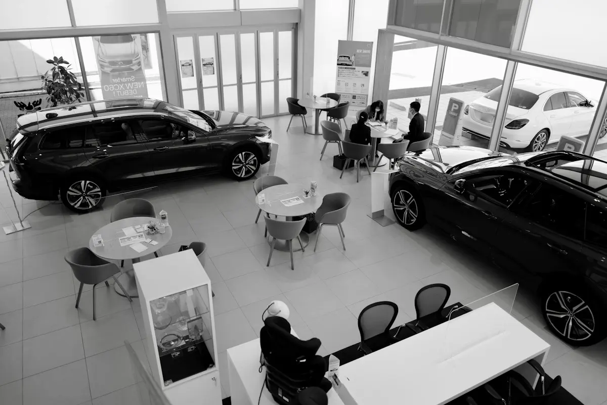Customers and staff at desks inside a car showroom