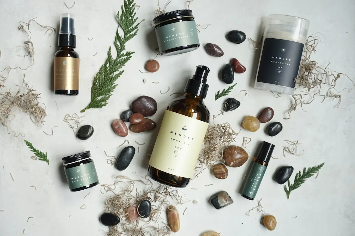 Skincare products arranged with smooth stones