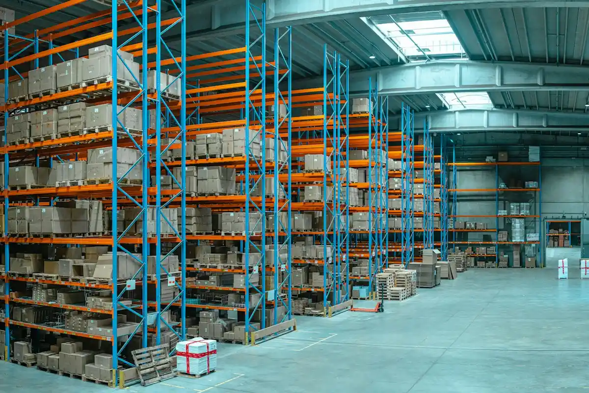 Tall racks of palletized stock in a distribution warehouse