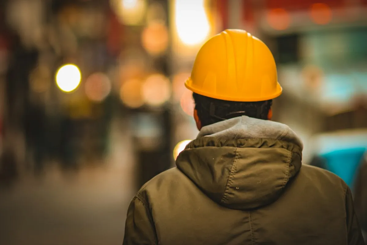 Technician in a hard hat at a building site