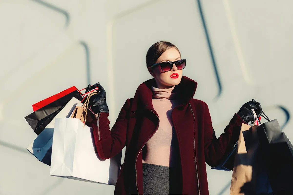 Shopper holding paper shopping bags