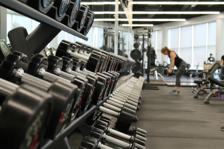 Woman training in a gym surrounded by equipment