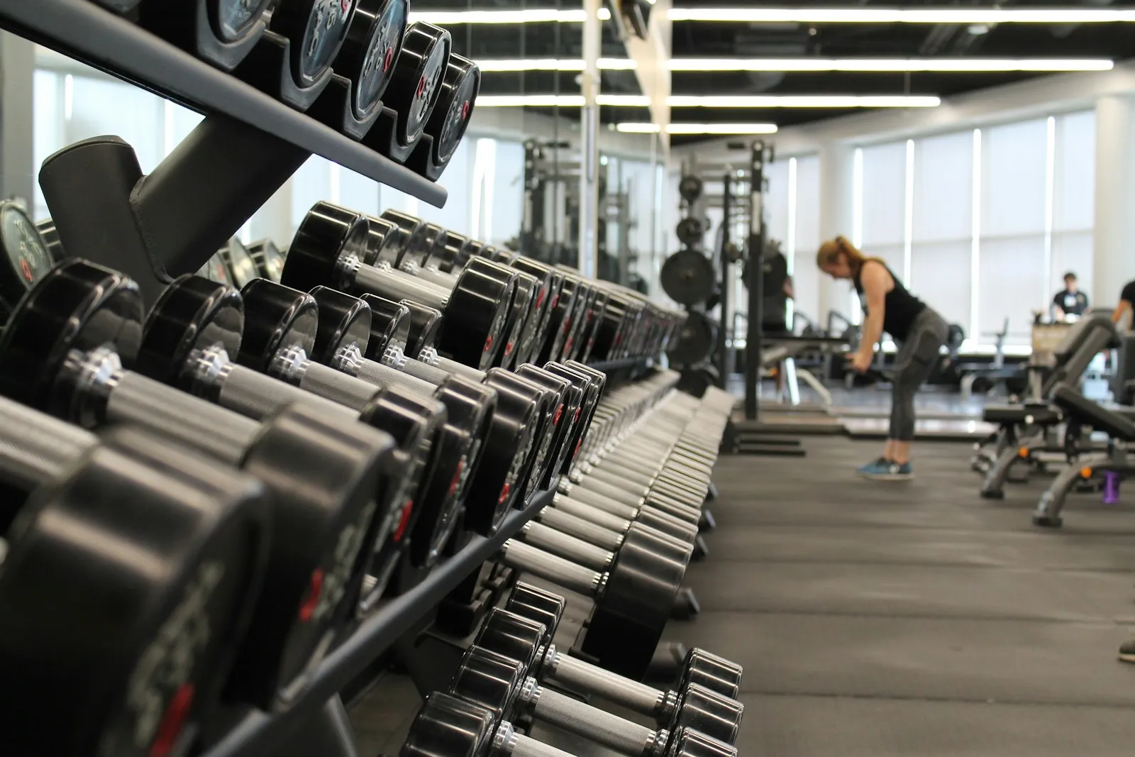 Woman training in a gym surrounded by equipment