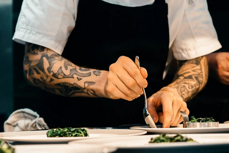 Chef plating a dish in a restaurant kitchen