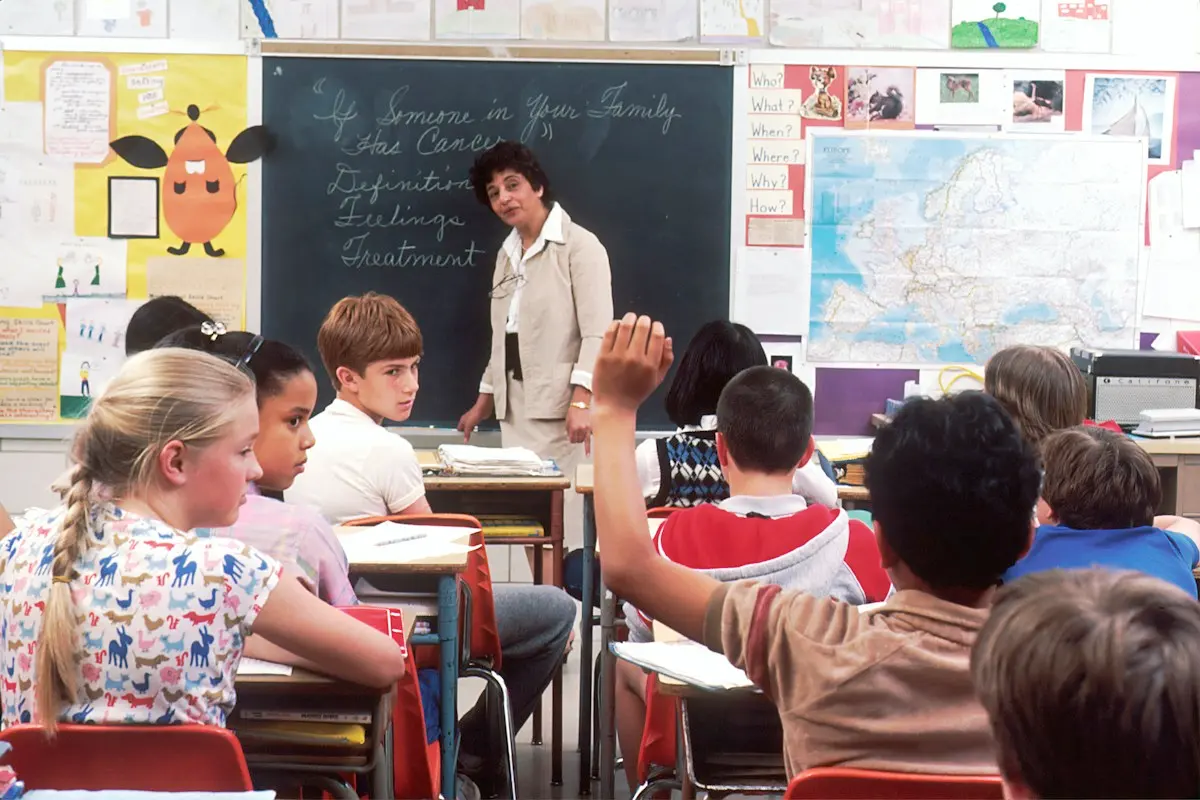 Teacher standing in front of children in a classroom