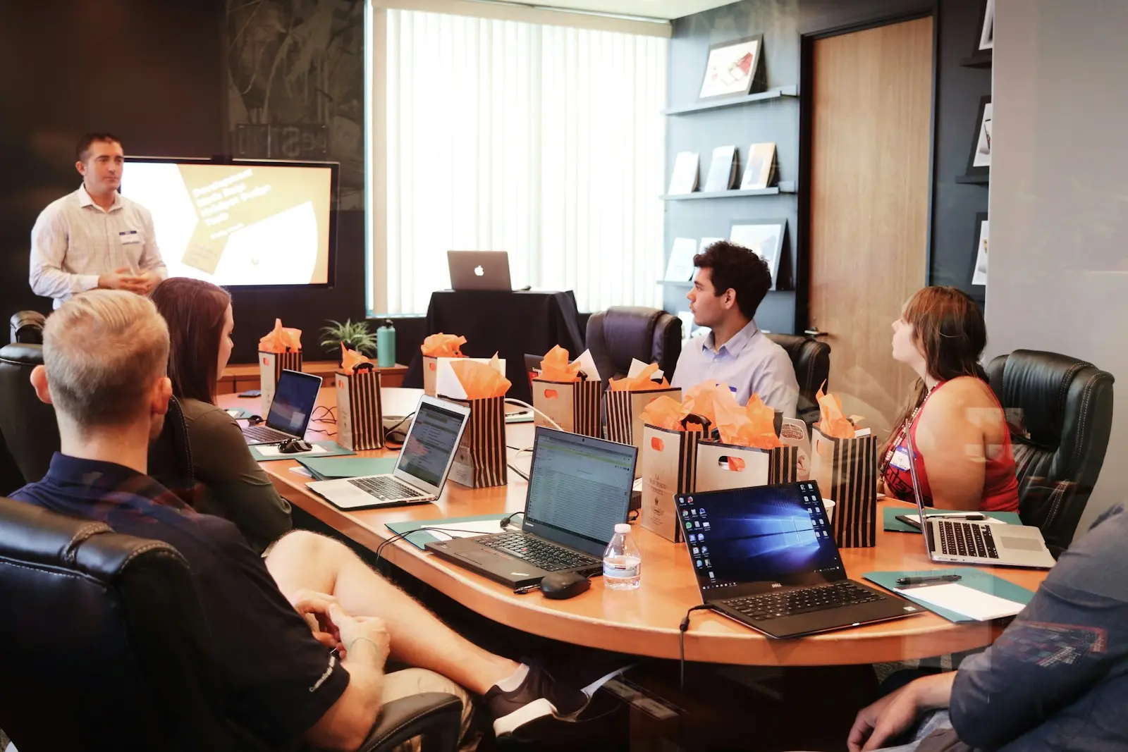 Consultant presenting to a team around a table
