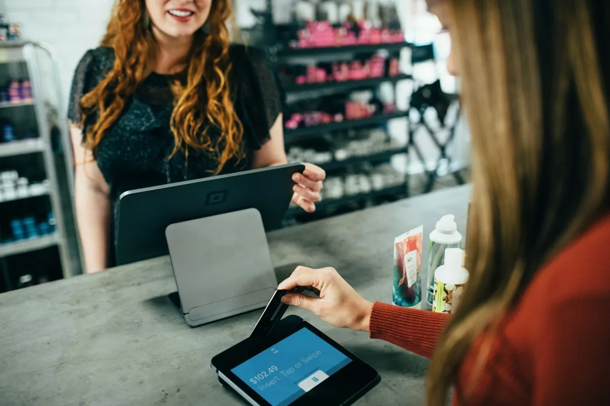 Customer paying by card at a store counter