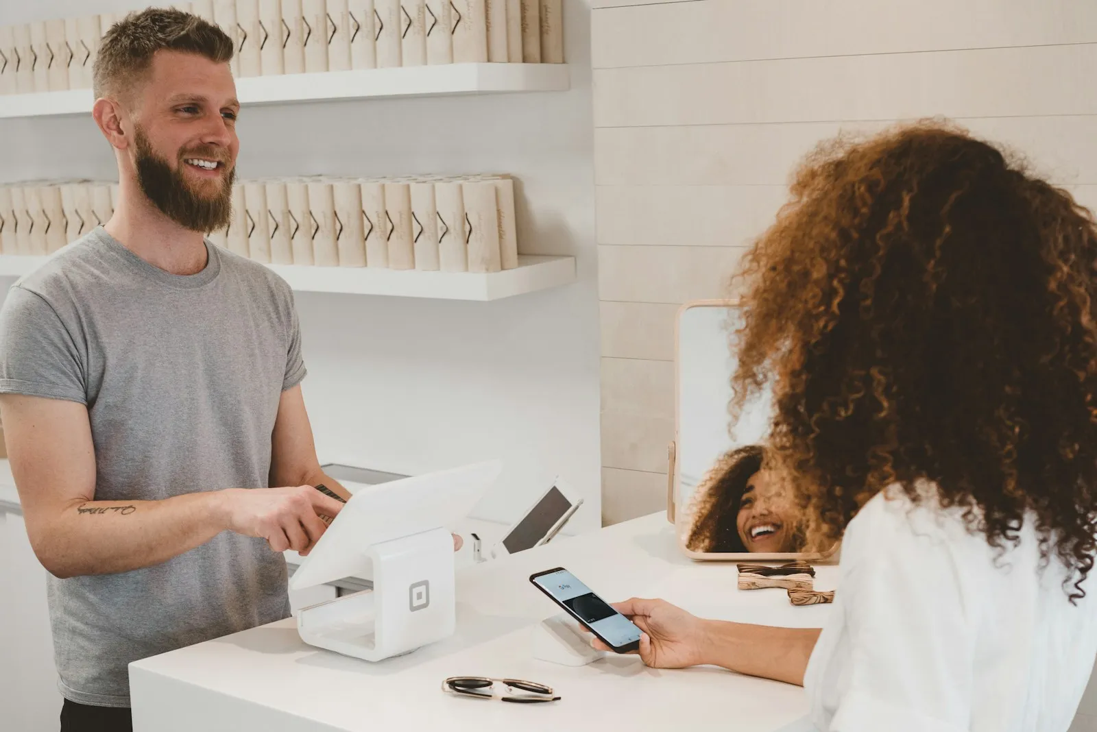 Cashier serving a customer at a store counter