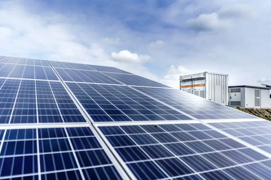 Rows of solar panels beside an industrial building